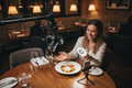 Food influencer filming a beautifully plated gourmet dish at an upscale restaurant